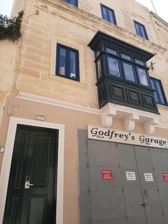 a building with a window and a door at Hammock Vibes Town House in Sliema