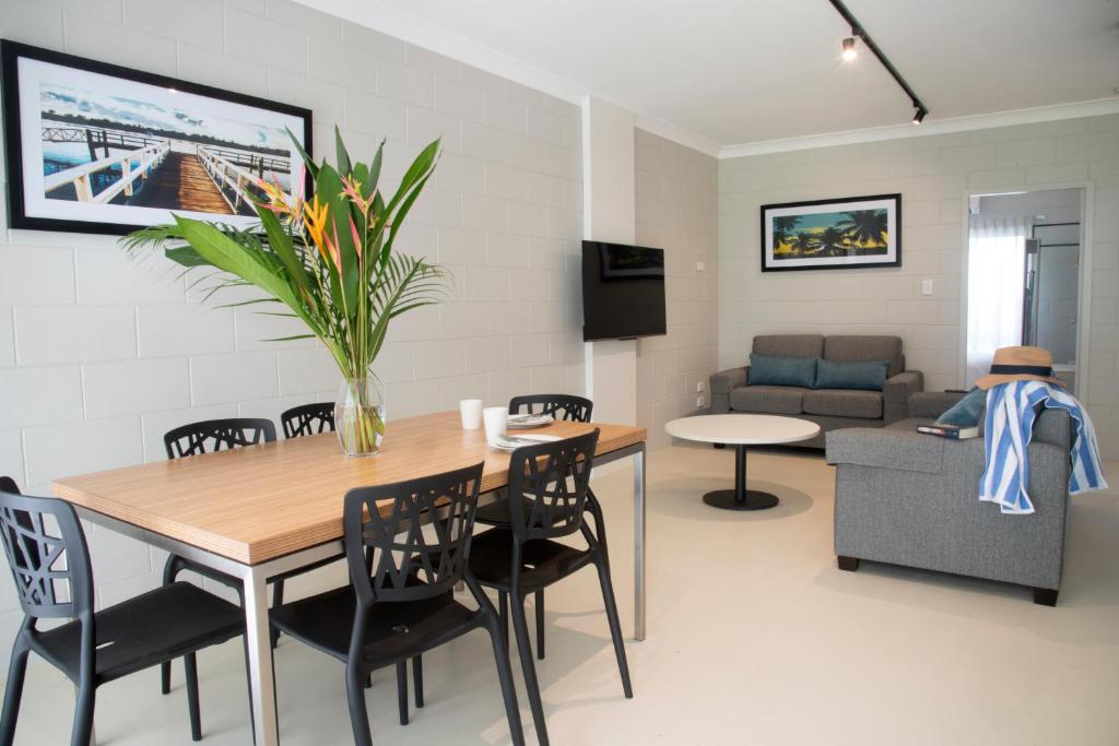 a living room with a table and chairs and a couch at Apartments at Mission Beach in Mission Beach