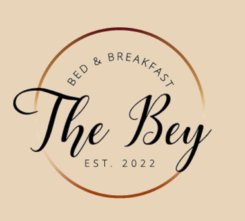 a logo for the key east brides breakfast the key at The Bey Bed and Breakfast in El Socorro