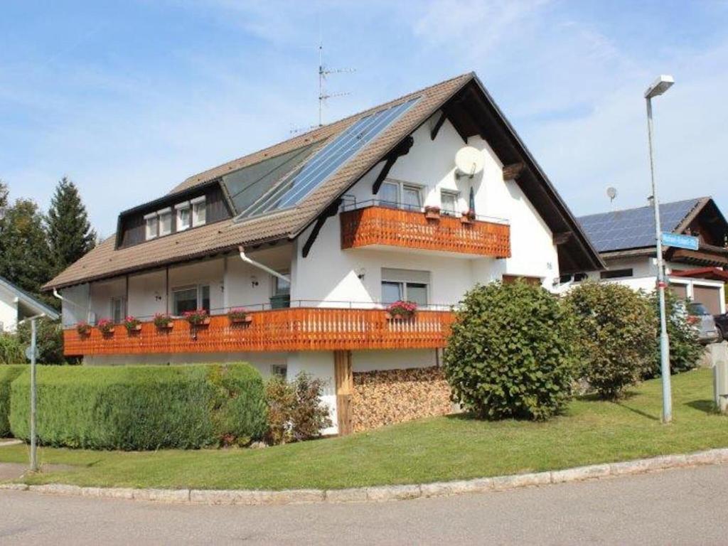 a house with a roof with a dog on the balcony at Cozy Apartment in Herrischried near Black Forest in Herrischried