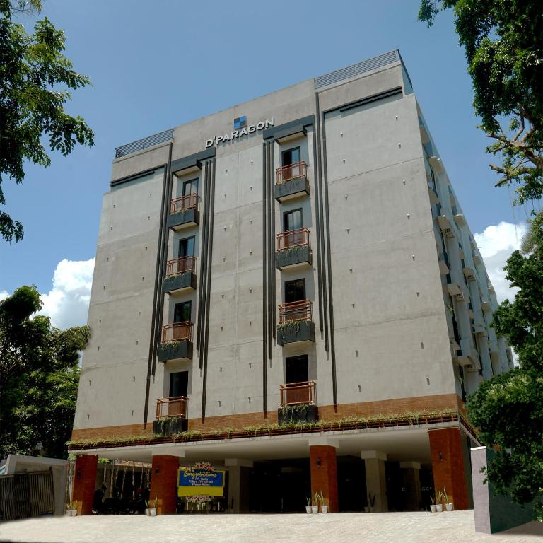 a tall white building with balconies on it at Dparagon Menteng Jakarta in Jakarta