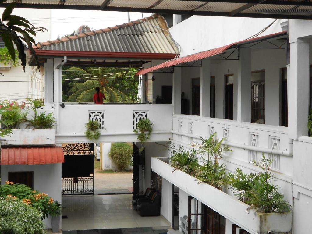 ein Gebäude mit Topfpflanzen auf den Balkonen in der Unterkunft Shanith Guesthouse Negombo in Negombo