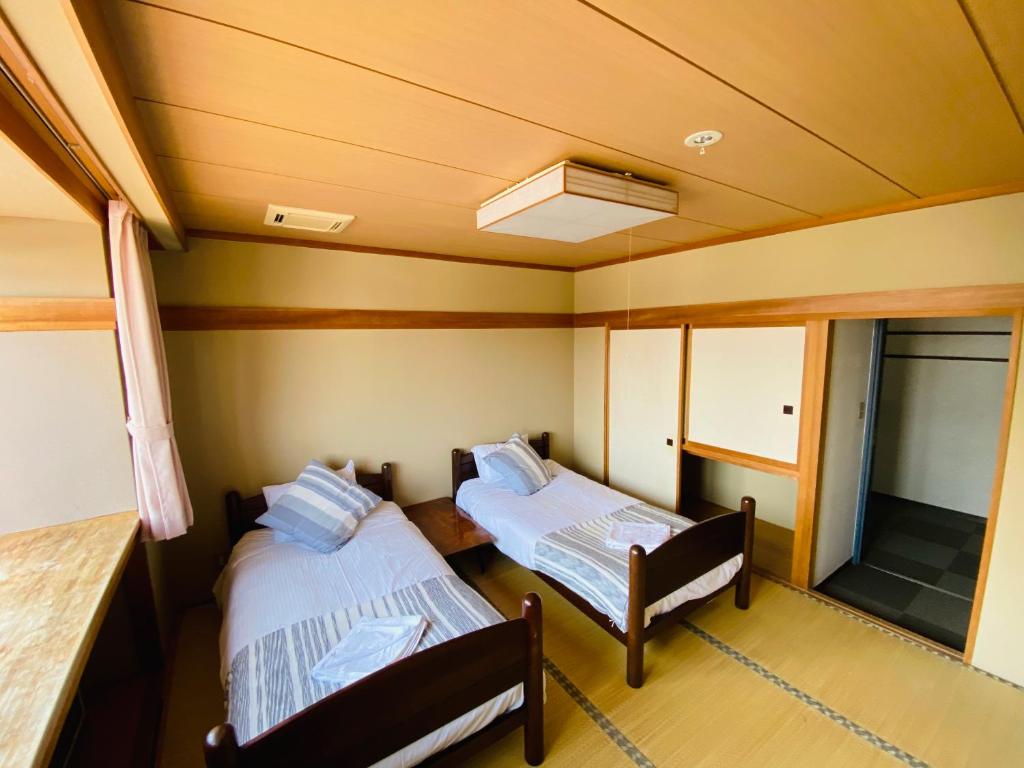 Postel nebo postele na pokoji v ubytování Red Fox Lodge Myoko