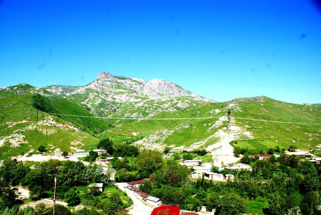 a view of a mountain with trees and houses at Spring Family Guest House in Tersak