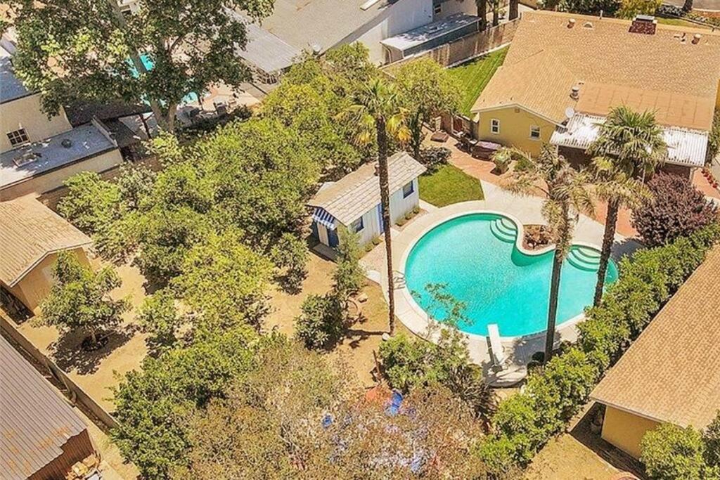 Cette chambre offre une vue sur une maison dotée d'une piscine. dans l'établissement Spacious Home with Garden & Pool, à Northridge