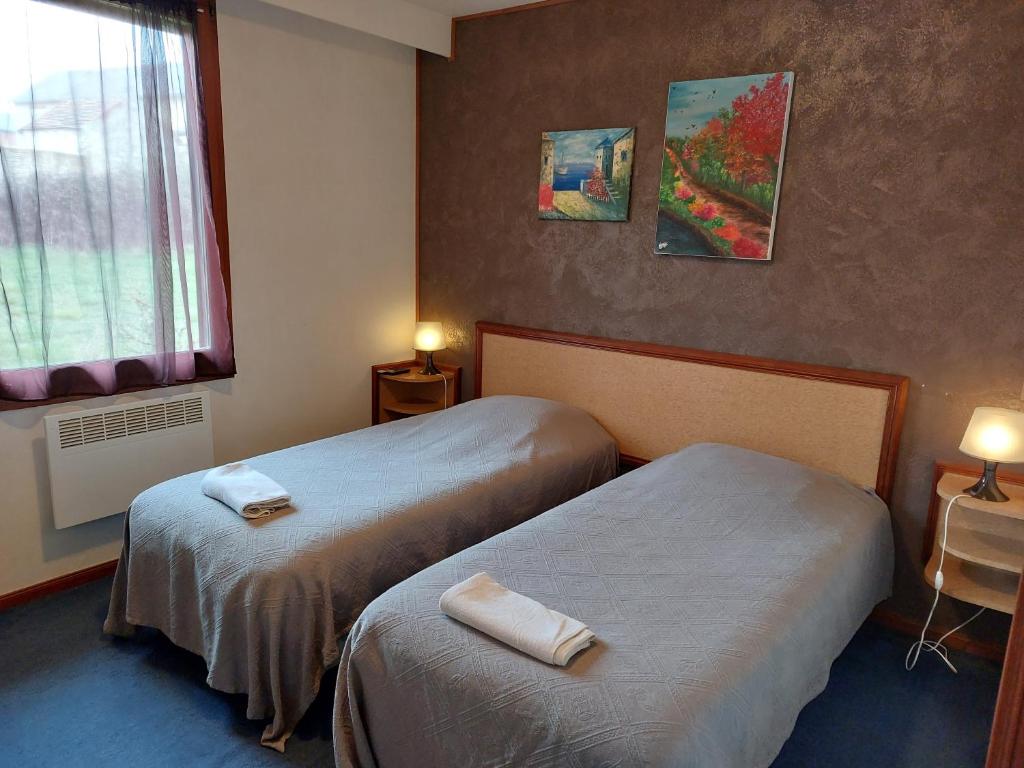 Postel nebo postele na pokoji v ubytování Le Magiot