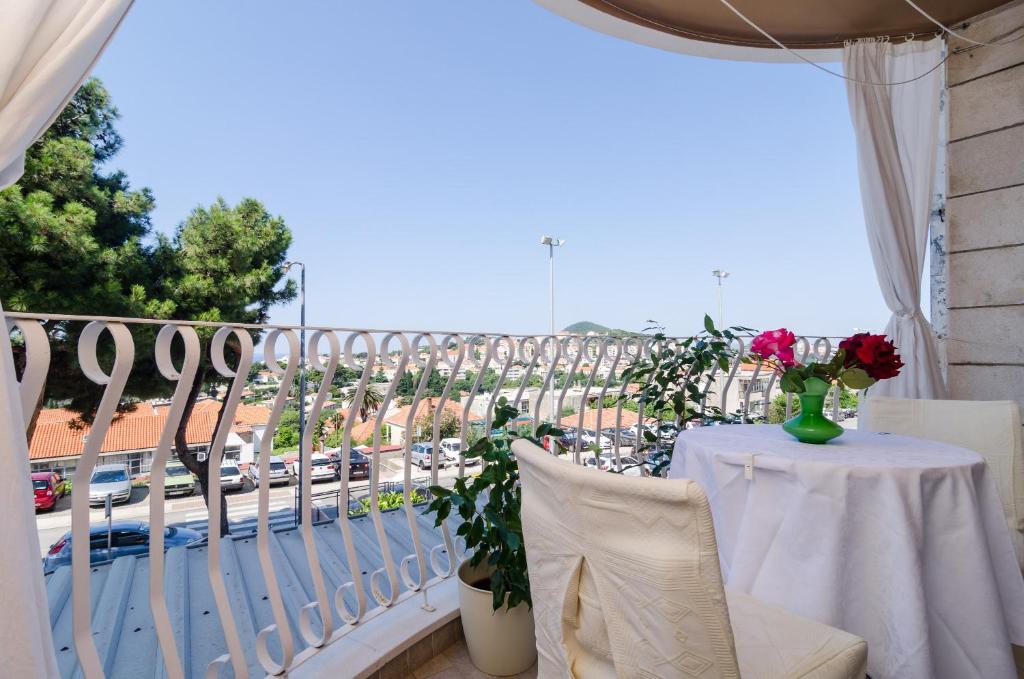 a balcony with a table and a view of a street at Rooms Jelka in Dubrovnik