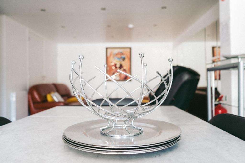 a glass bowl sitting on top of plates on a table at Kimia House in Osny