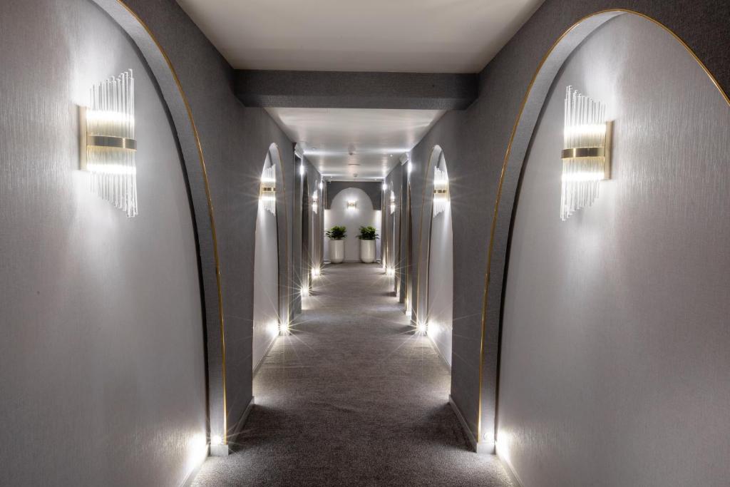 a hallway with arches and lights on the walls at Walton Gardens Pera in Istanbul