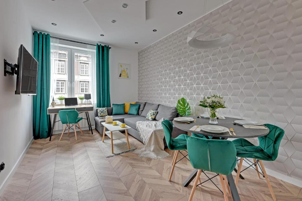 a living room with a couch and a table at Ideal Apartments Arkady in Gdańsk