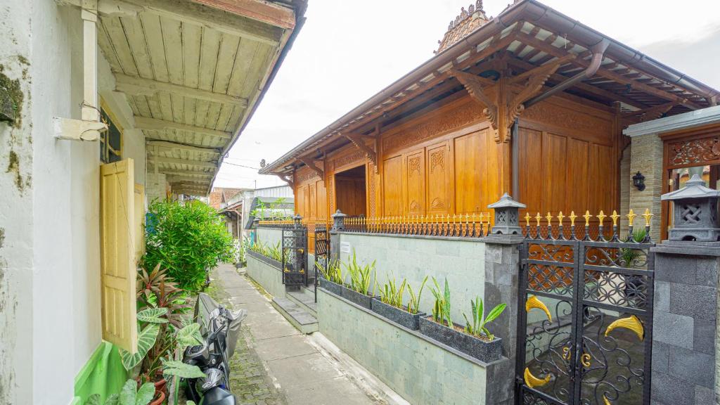 a building with a balcony with a fence at Villa Joglo Kawung in Yogyakarta