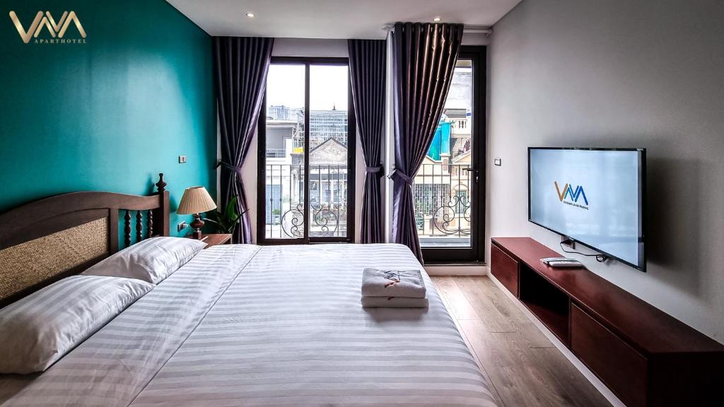 Postel nebo postele na pokoji v ubytování VNAHOMES APARTHOTEL