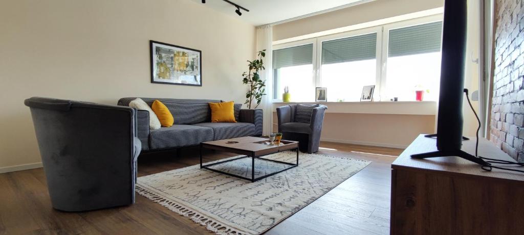 a living room with a couch and a table at Apartment 906 in Prishtina in Pristina