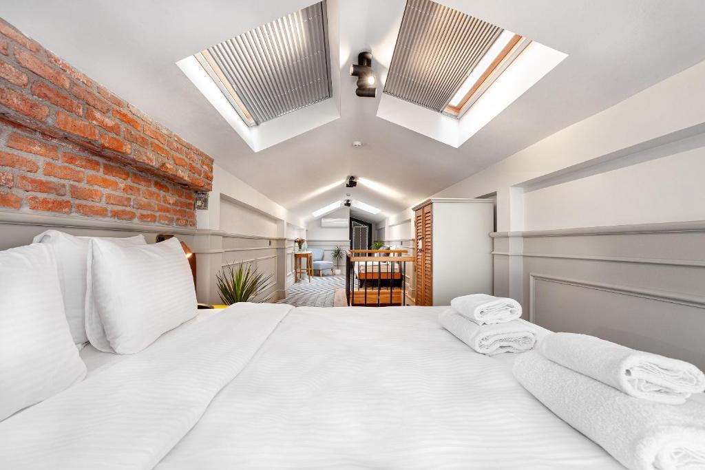 a bedroom with a large white bed with white pillows at World House Boutique Hotel Galata in Istanbul