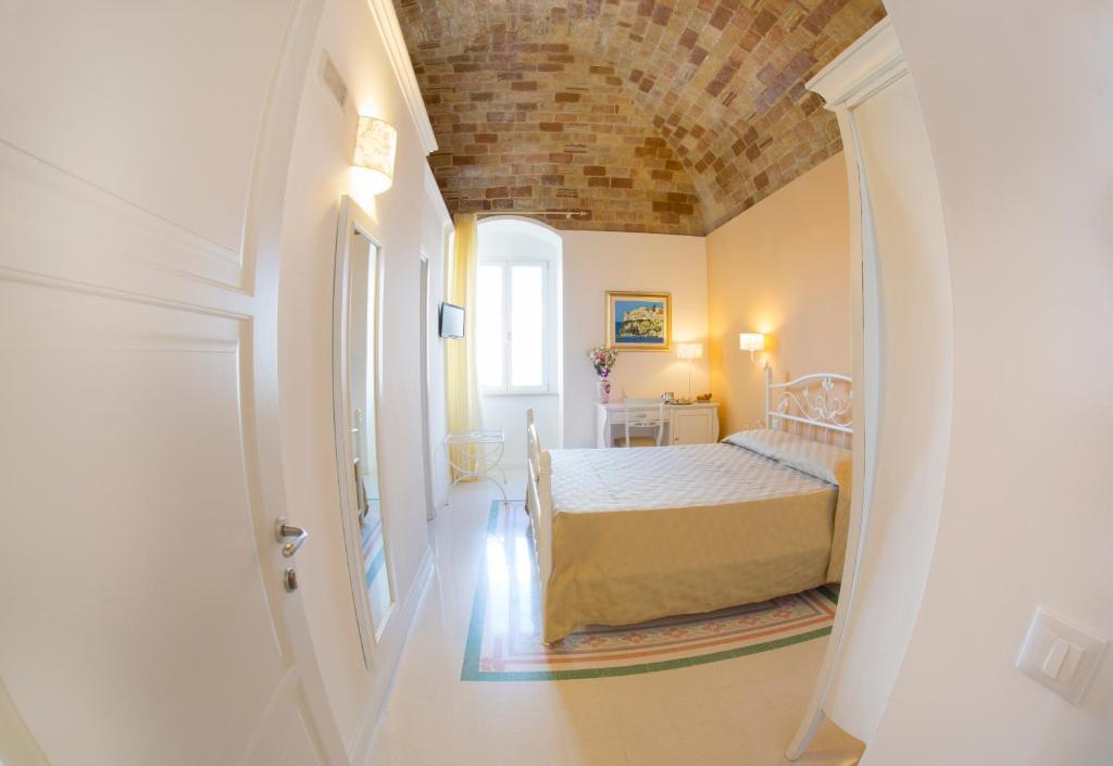 a bedroom with a bed with a brick ceiling at B&B Monsignore in Vieste