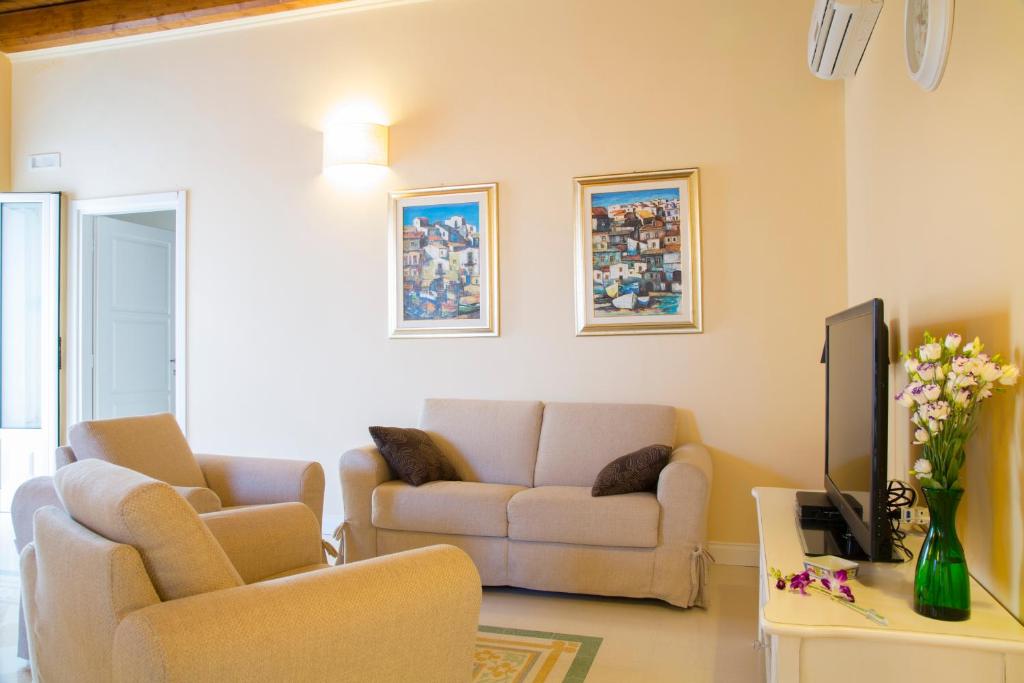 a living room with a couch and a tv at B&B Monsignore in Vieste