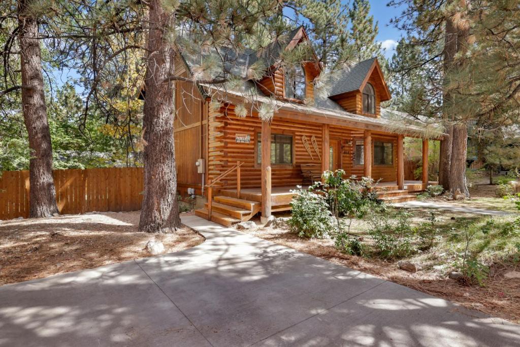 a log cabin in the woods with a driveway at Dreams of Summit-1120 by Big Bear Vacations in Big Bear Lake