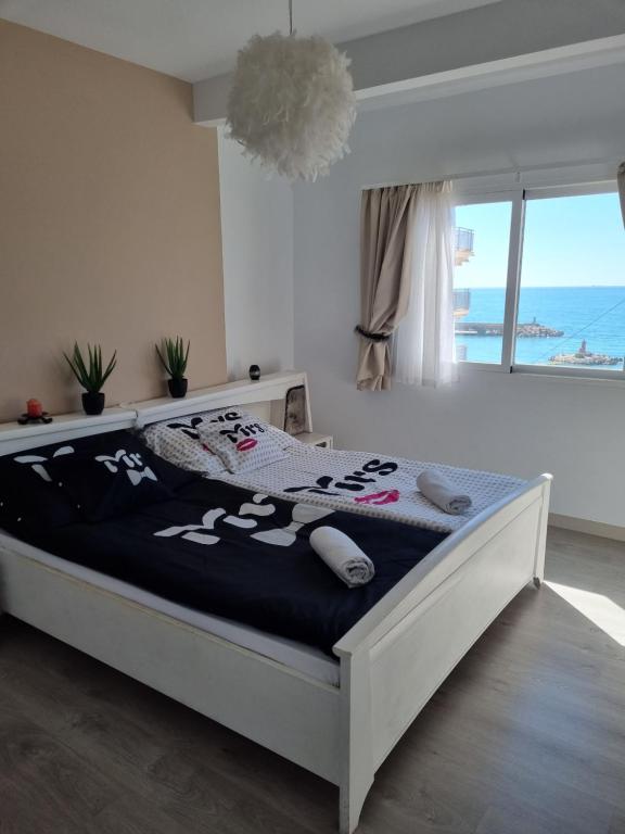 a bedroom with a bed with a view of the ocean at Vistal al mar Palasiet in Era de Soler