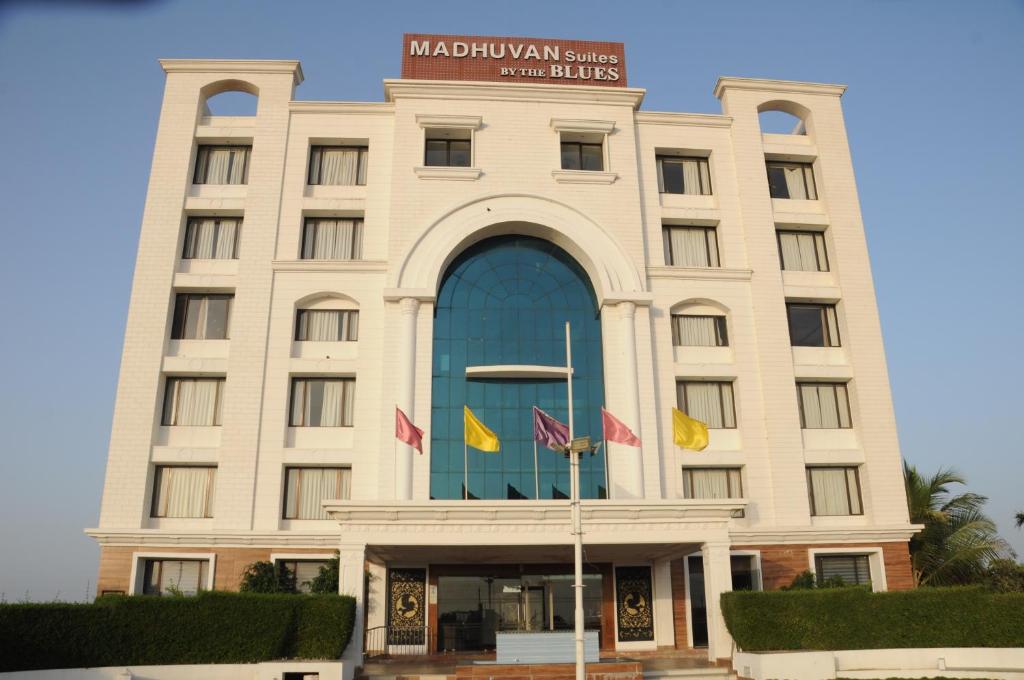 a building with flags in front of it at Madhuvan Suites By Blues in Dwarka