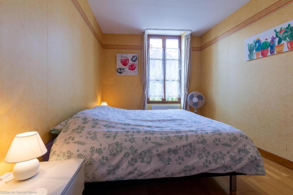 Tempat tidur dalam kamar di Le Papillon