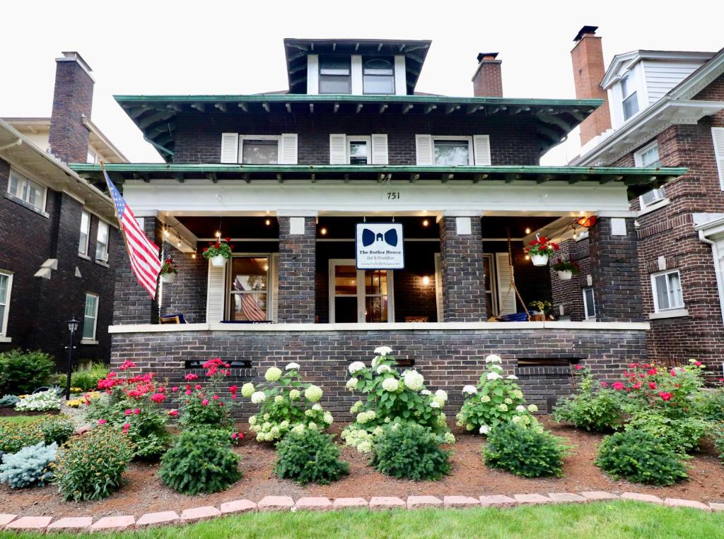 a house with a bunch of flowers in front of it at The Butler House Bed & Breakfast in Niagara Falls