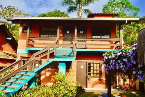 a model of a house with blue steps and flowers at Sunshine Residencial in Bombinhas