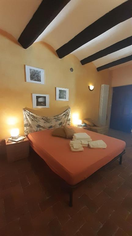 a bedroom with a bed with two towels on it at La Marmotta in Luserna San Giovanni