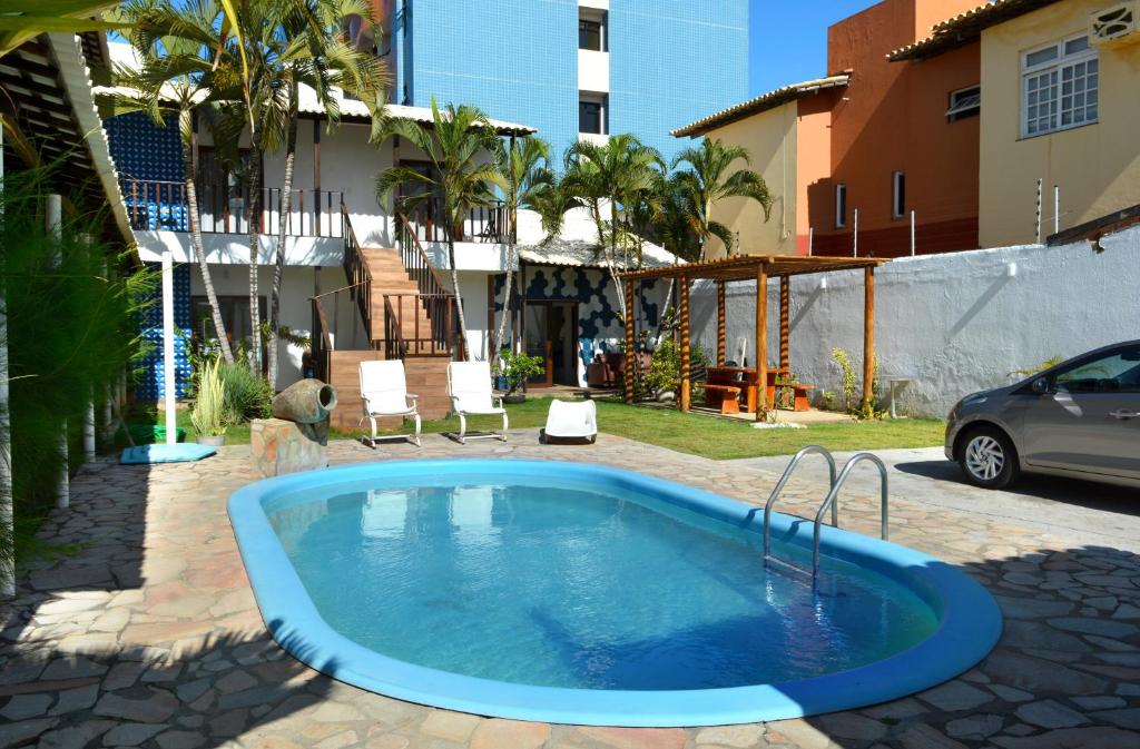 a swimming pool in the yard of a house at Villa Atalaia in Aracaju