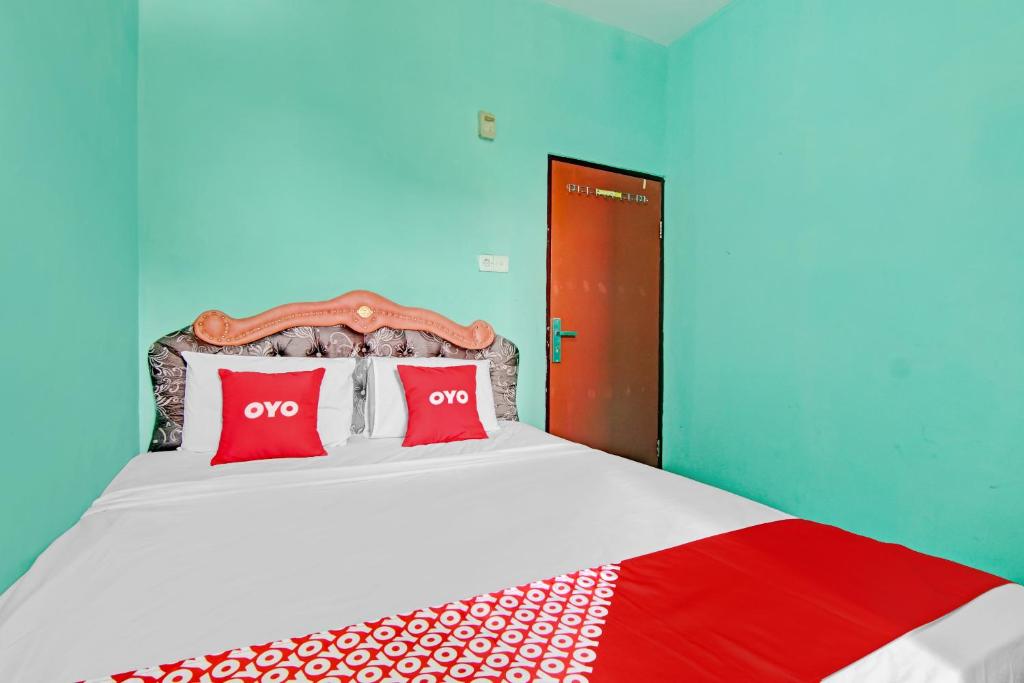 Ένα ή περισσότερα κρεβάτια σε δωμάτιο στο OYO 3063 Homestay 22 Syariah