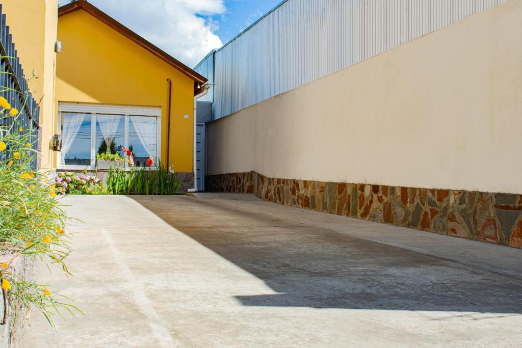 a yellow and white building next to a building at Departamento Casimiro-Nuevo Amplio en Zona Centro in El Calafate