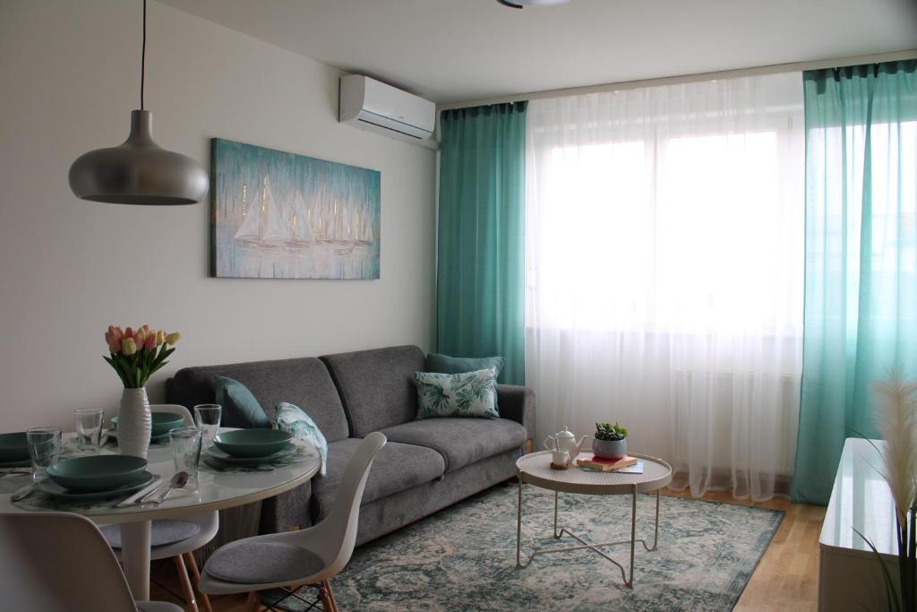a living room with a couch and a table at Arena Zagreb Premium Apartment in Zagreb