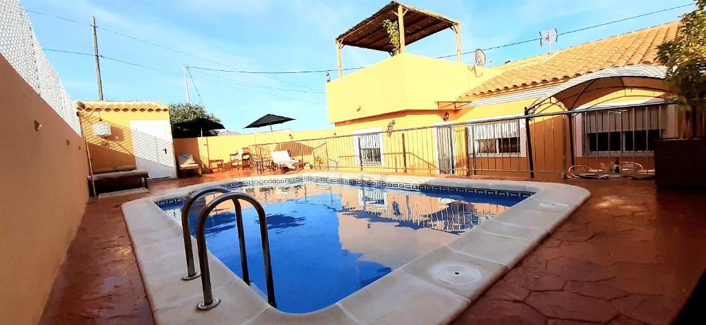 a swimming pool in front of a house at Villa Flor de Loto in Palazuelos