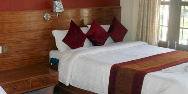 Letto o letti in una camera di Chitwan Forest Resort , Chitwan National Park