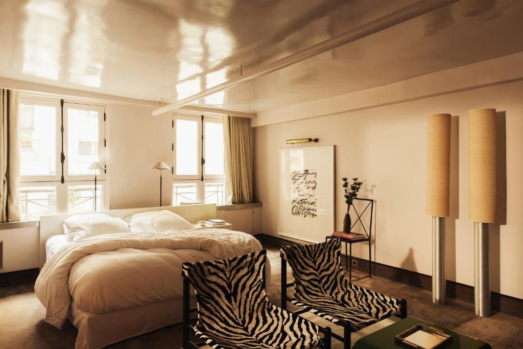 a bedroom with a bed and a zebra print chair at Pied A Terre - Tuileries in Paris