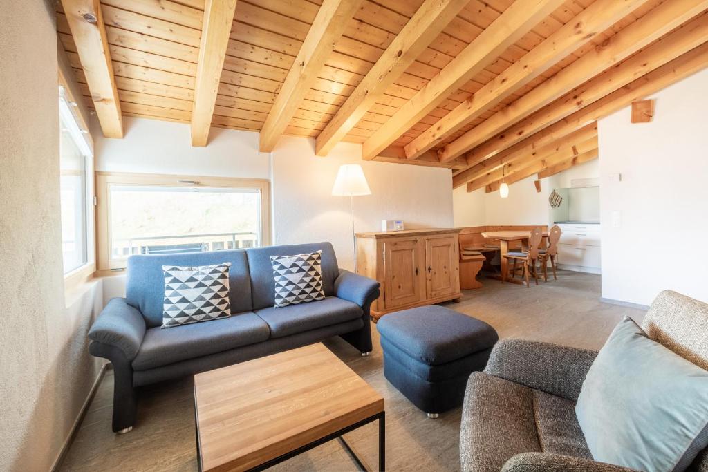 a living room with a couch and a table at Casa Darschalè 11 in Laax