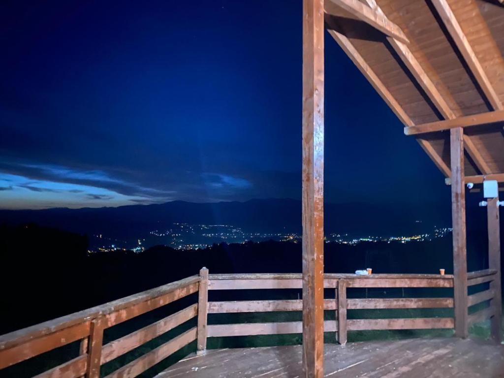 a gazebo with a night view of the city at Cabana Chilii in Cîmpulung