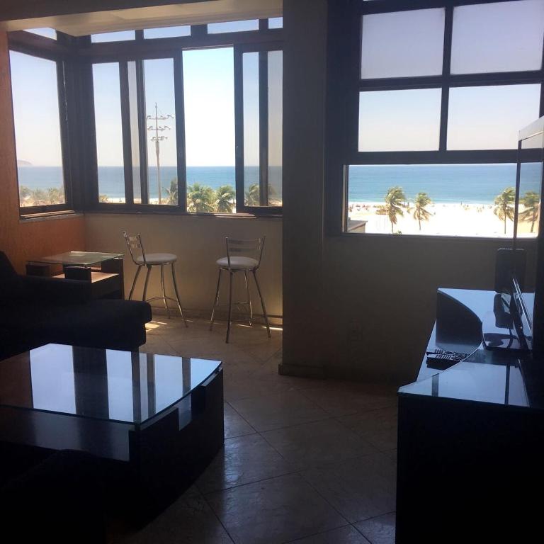 a living room with a view of the beach at Apartamento Assu in Rio de Janeiro