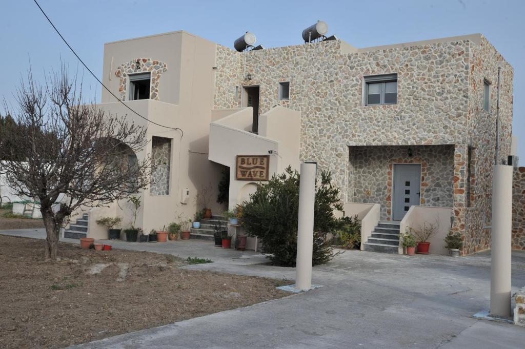 a building with two birds on the top of it at Blue Wave in Kefalos