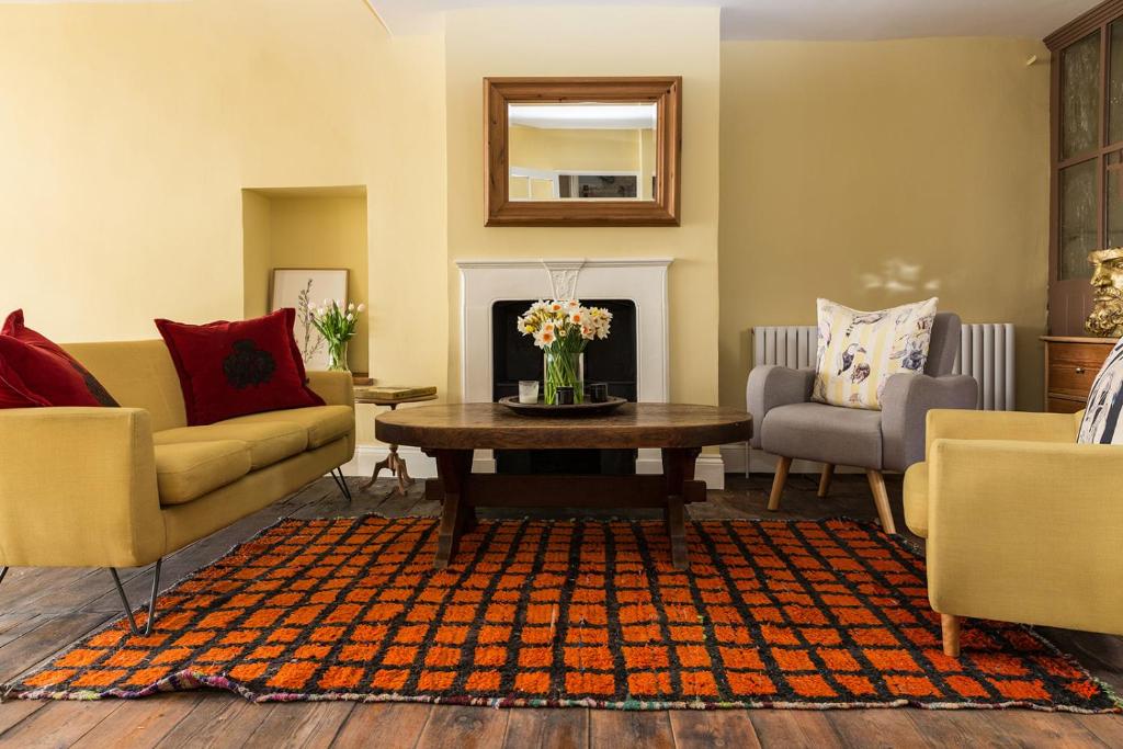 a living room with two couches and a coffee table at Severnside Press BnB in Newnham