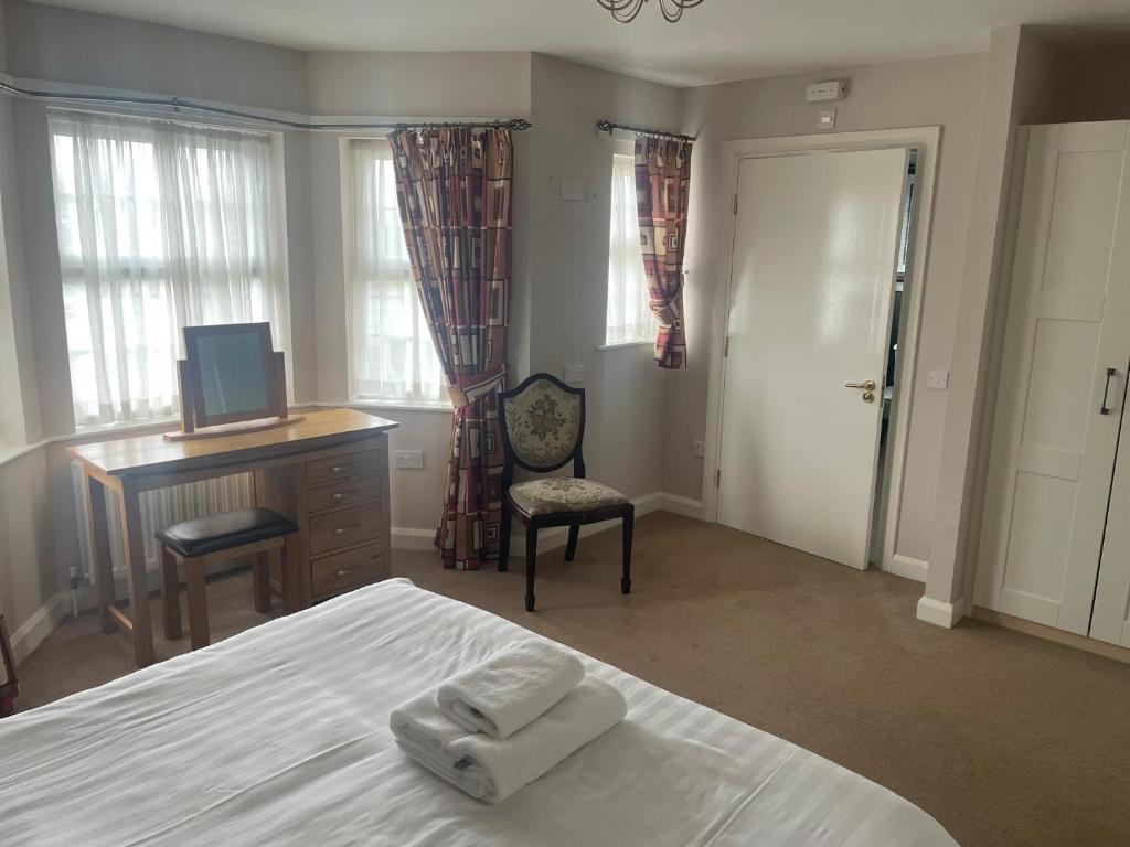 a bedroom with a bed and a desk and a computer at The Moorings Hotel in Edmondsley