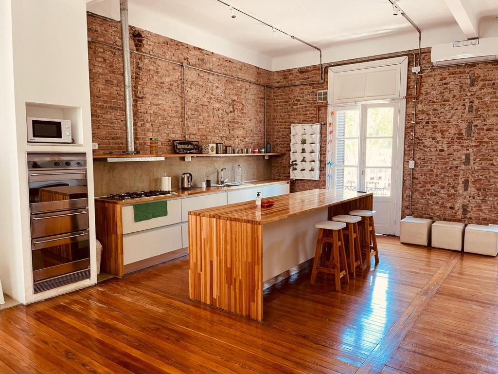 a kitchen with a wooden island in a room at SANTELMO in Buenos Aires