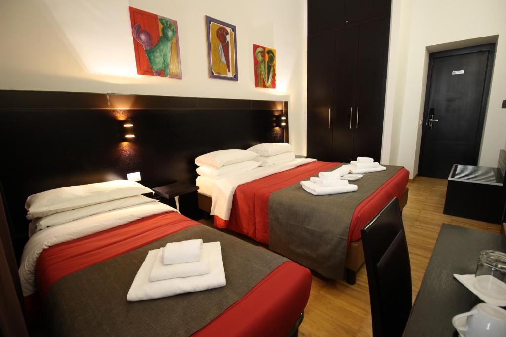 Habitación de hotel con 2 camas y toallas. en Guest House della Valle Roma en Roma