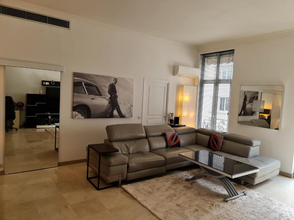 a living room with a couch and a table at Center palais in Cannes