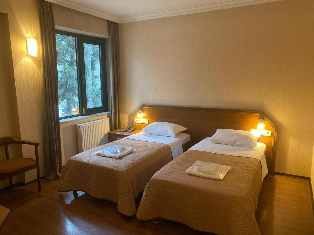 Postel nebo postele na pokoji v ubytování Batesta Hotel