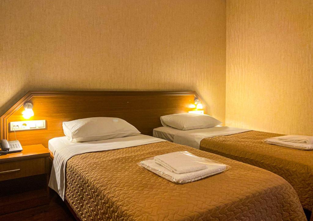 Postel nebo postele na pokoji v ubytování Batesta Hotel