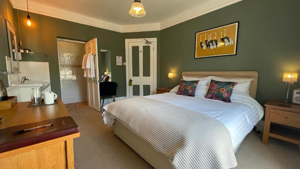 
a bedroom with a large bed and a large window at Southcliffe B&B in Lynton
