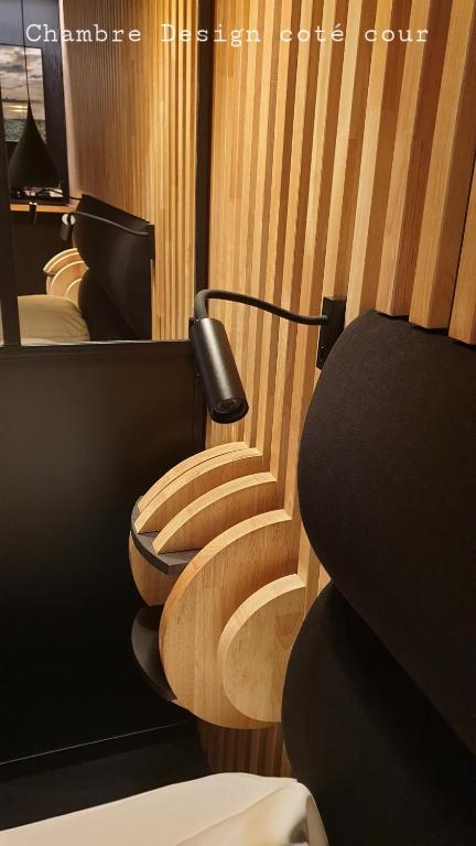 a row of wooden toilets in a room at Hôtel Les Brises in La Rochelle