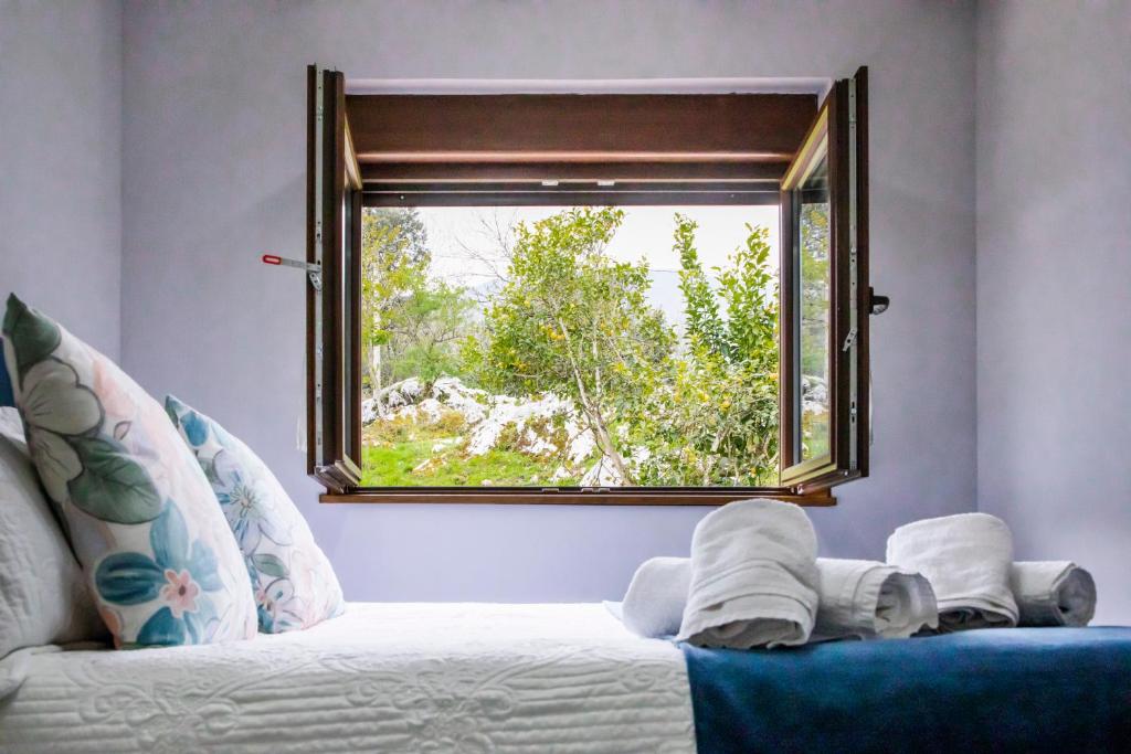 ventana en una habitación con sofá blanco y ventana en Casa de campo en Llanes para 8 personas, en La Galguera