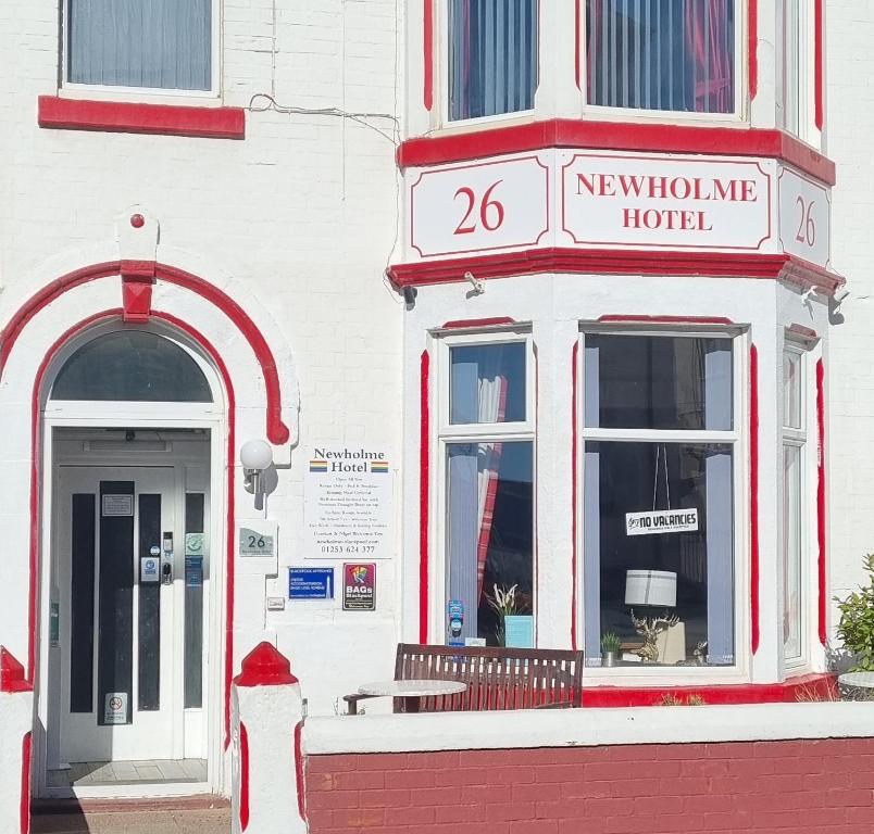a red and white building with a hotel at Newholme Hotel in Blackpool