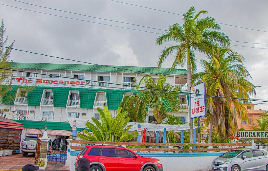 a red car parked in front of a building at The Buccaneer in Montego Bay